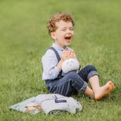 laughing, one person, barefoot, color image, sitting, grass, outdoors, happiness, child, nature, enjoyment, childhood, portrait, cute, carefree, playful, horizontal, vitality, toddler, brown hair, fun, 2-3 years, looking at camera, growth, focus on foreground, smiling